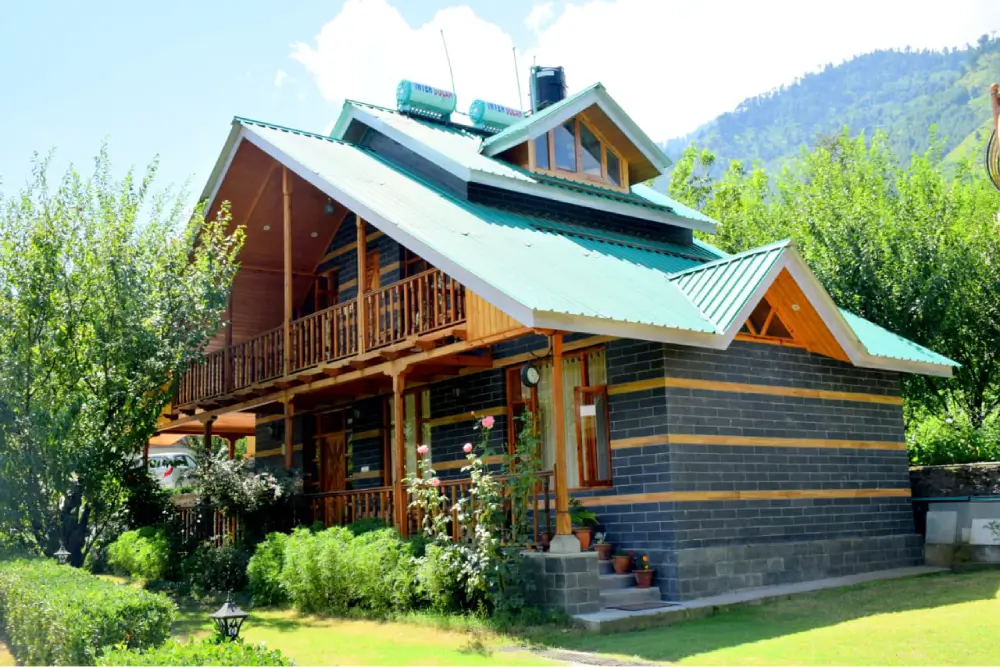 Interior of the Snowdrop room at Shree Ganga Cottages with a double bed and wooden finishes