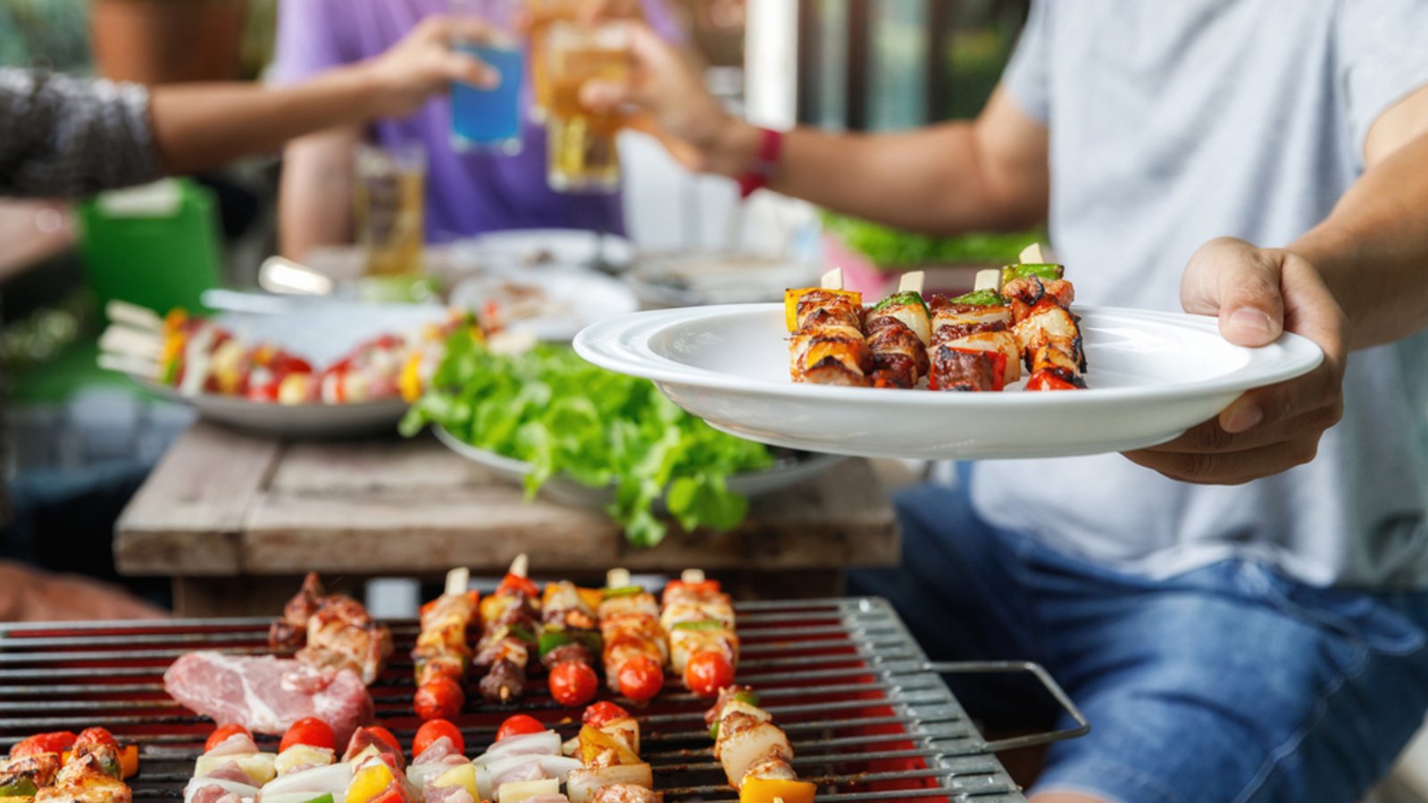 Barbecue grill with skewers being cooked outdoors at Shree Ganga Cottages